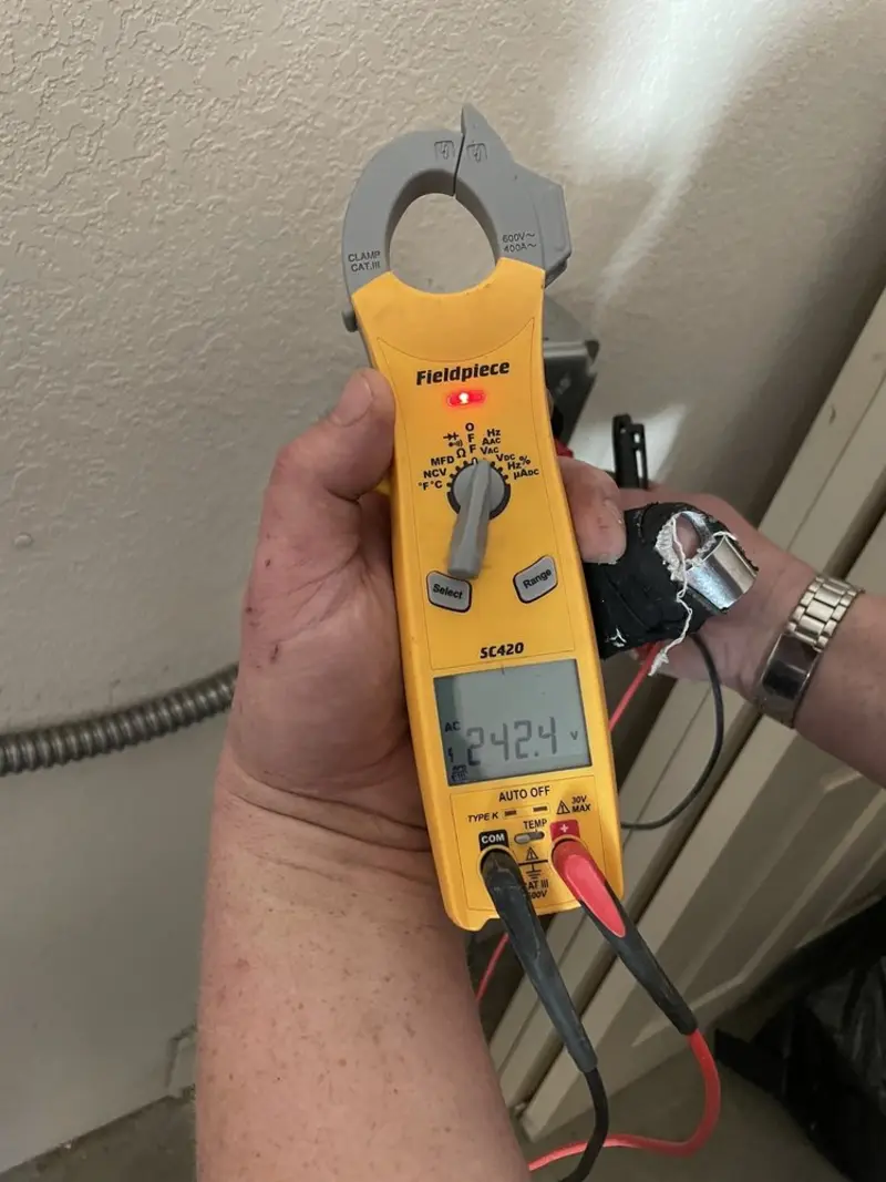 Voltage testing with clamp meter during Recessed Lighting Installation in Camden